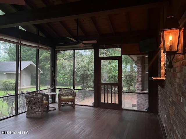 sunroom featuring lofted ceiling with beams and wood ceiling