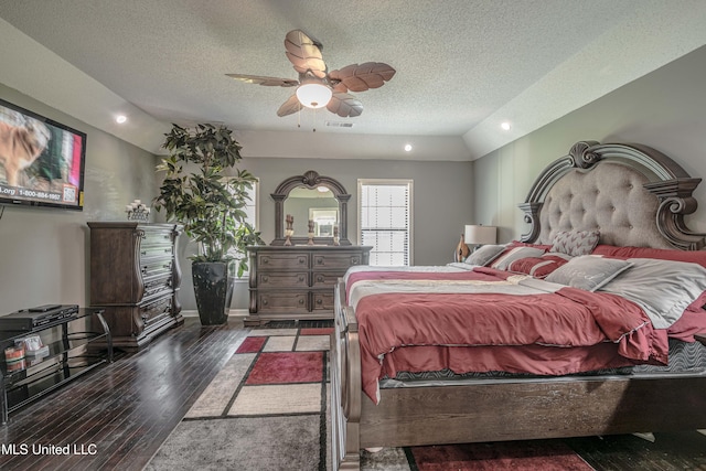 bedroom with ceiling fan, lofted ceiling, a textured ceiling, and dark hardwood / wood-style floors