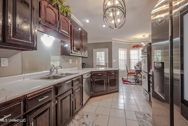 kitchen with stainless steel appliances, hanging light fixtures, sink, light tile patterned floors, and crown molding