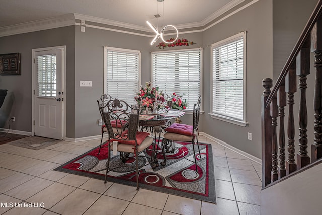 dining area with a chandelier, light tile patterned floors, and ornamental molding