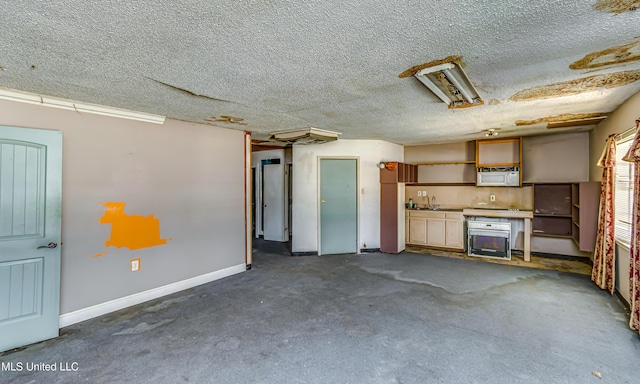 garage with a sink and baseboards