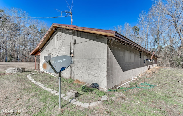 view of side of home featuring concrete block siding