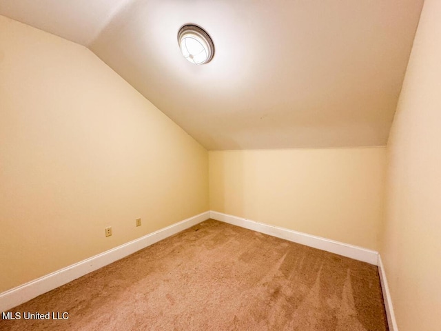 bonus room with carpet flooring and lofted ceiling