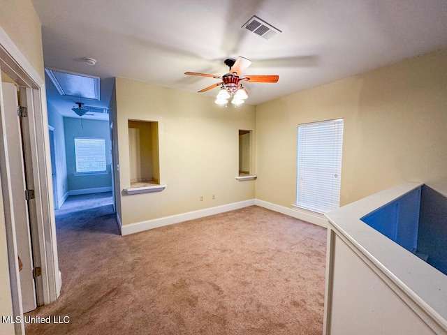 carpeted spare room with ceiling fan