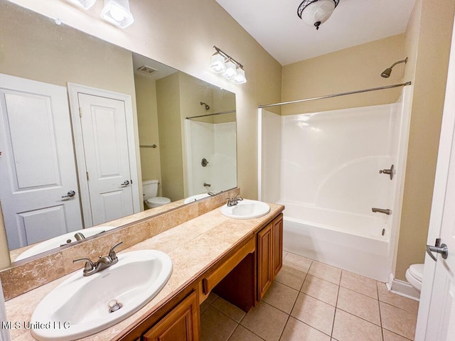 full bathroom featuring toilet, tile patterned flooring, vanity, and shower / bathing tub combination