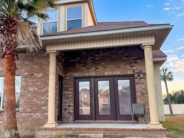 exterior entry at dusk featuring french doors