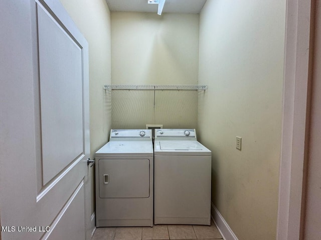 washroom with light tile patterned flooring and washing machine and dryer