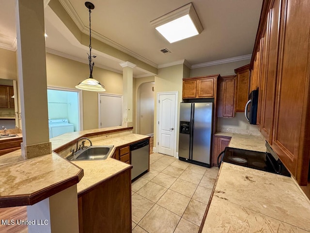 kitchen with decorative light fixtures, sink, appliances with stainless steel finishes, and crown molding