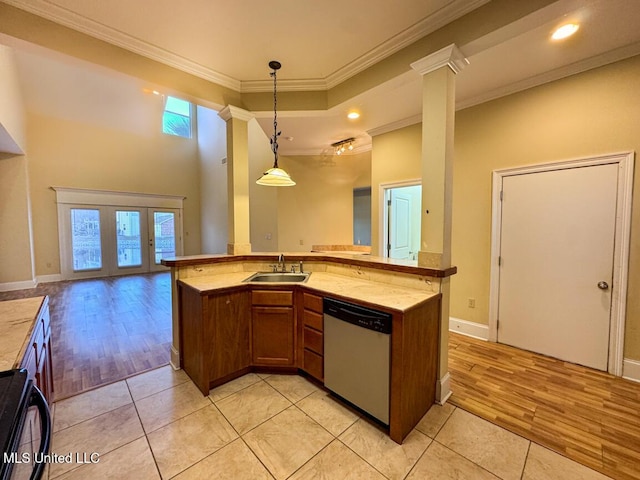 kitchen featuring crown molding, dishwasher, sink, a kitchen island with sink, and decorative columns