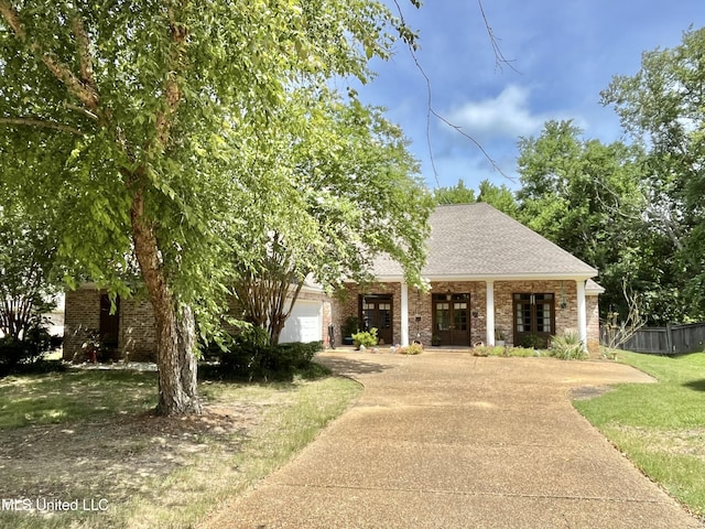 140 Whisper Lake Blvd, Madison, MS 39110 - view of front of home with concrete driveway, brick siding, french doors, and a garage