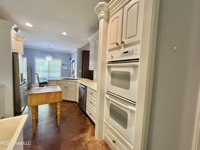 140 Whisper Lake Blvd, Madison, MS 39110 - kitchen featuring stainless steel appliances, a peninsula, finished concrete flooring, a sink, and light countertops