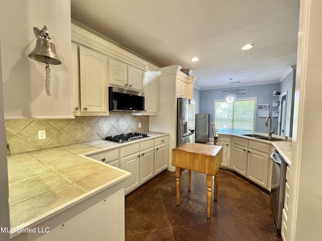 140 Whisper Lake Blvd, Madison, MS 39110 - kitchen featuring stainless steel appliances, a sink, ornamental molding, backsplash, and tile counters