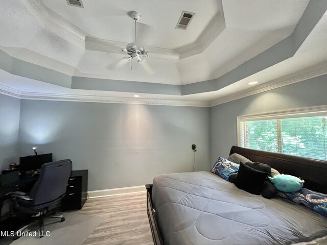 140 Whisper Lake Blvd, Madison, MS 39110 - bedroom with ornamental molding, a raised ceiling, an office area, light wood-style floors, and baseboards