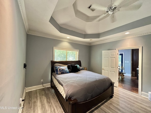 140 Whisper Lake Blvd, Madison, MS 39110 - bedroom featuring a raised ceiling, wood finished floors, baseboards, crown molding, and recessed lighting