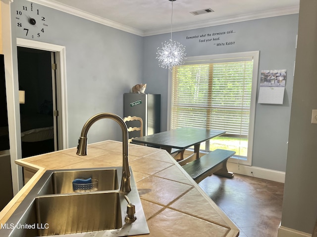 140 Whisper Lake Blvd, Madison, MS 39110 - kitchen featuring tile countertops, a sink, crown molding, baseboards, and a chandelier