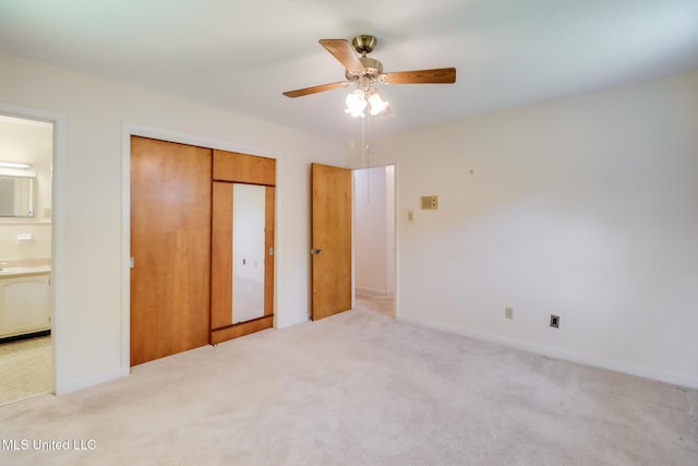 820 Lackland Dr, Biloxi, MS 39532 - unfurnished bedroom with carpet, a closet, ensuite bath, a ceiling fan, and baseboards
