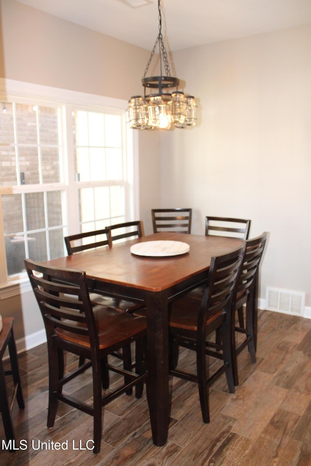 dining room with dark hardwood / wood-style flooring