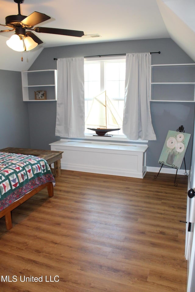 bedroom with dark wood-type flooring and vaulted ceiling