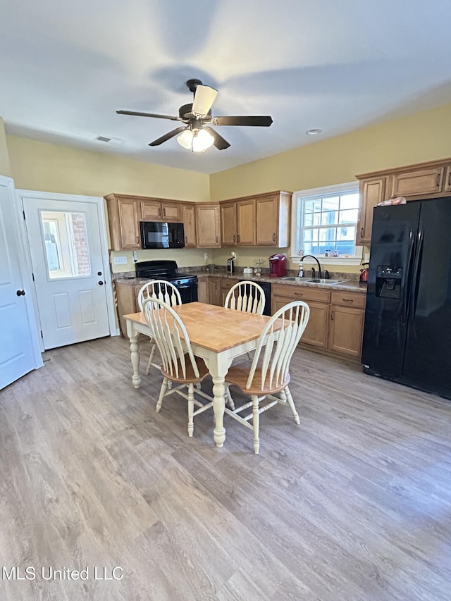 dining room with ceiling fan, sink, and light hardwood / wood-style floors