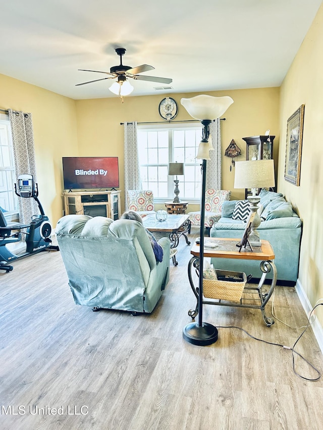 living room with ceiling fan and wood-type flooring