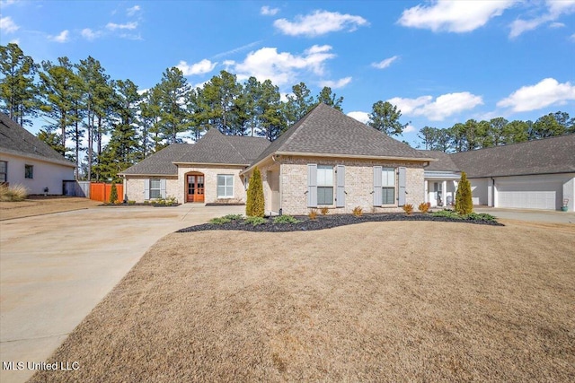 view of front of home with a garage and a front lawn