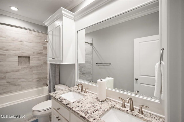 full bathroom with tiled shower / bath combo, crown molding, vanity, and toilet