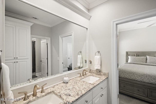 bathroom featuring ornamental molding and vanity