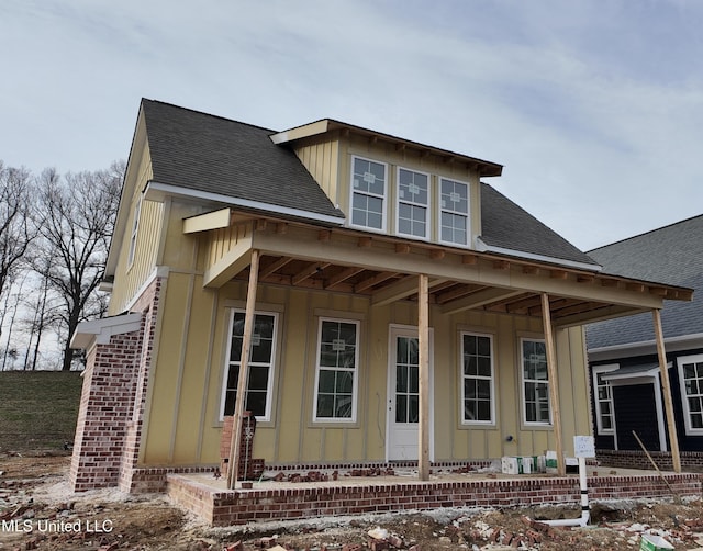 view of front of property featuring board and batten siding and roof with shingles