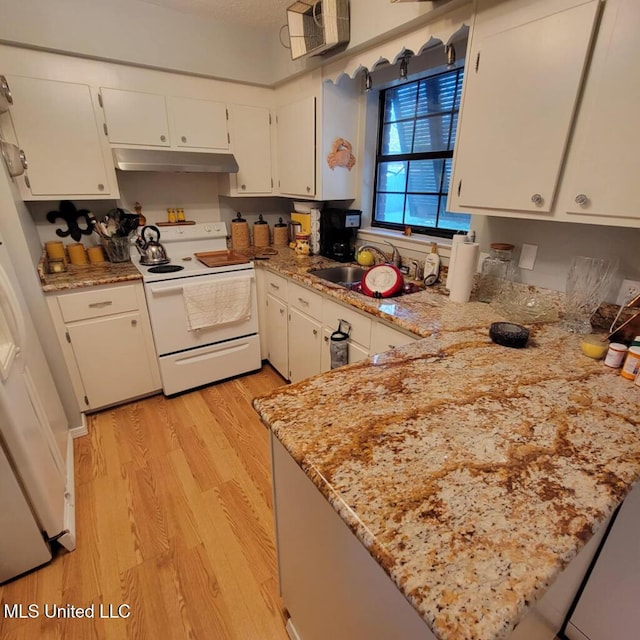 kitchen featuring kitchen peninsula, light wood-type flooring, white appliances, and white cabinetry