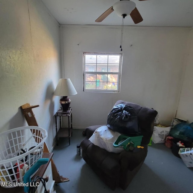 bedroom with ceiling fan and concrete floors