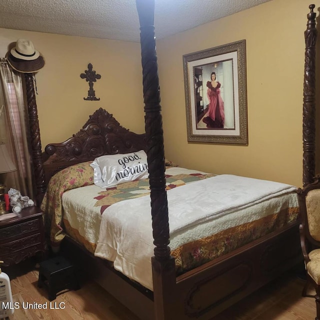 bedroom featuring a textured ceiling and light wood-type flooring