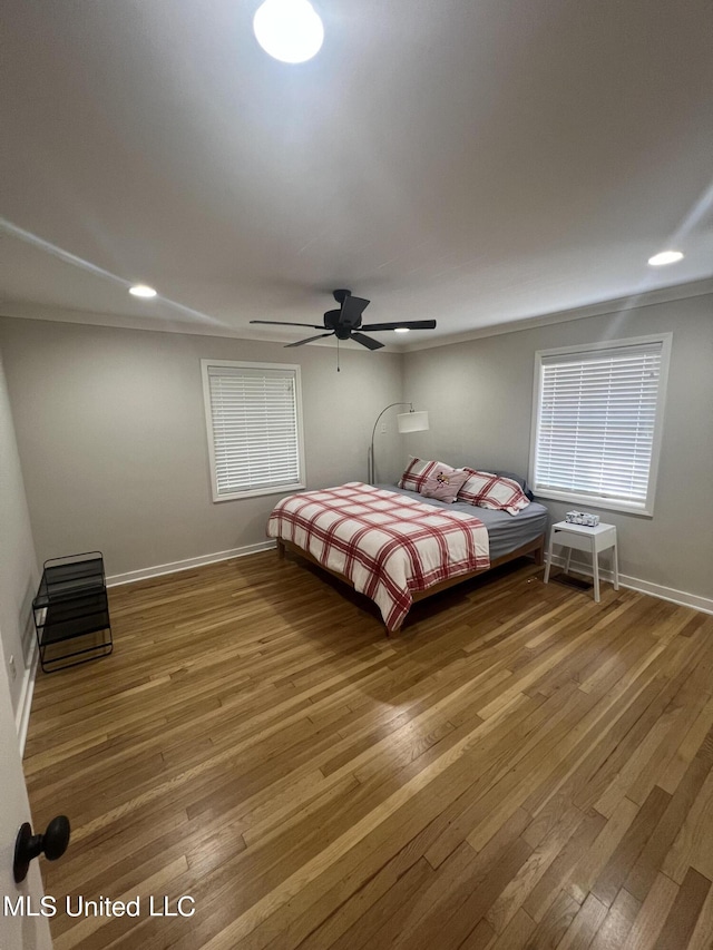 unfurnished bedroom featuring wood-type flooring and ceiling fan