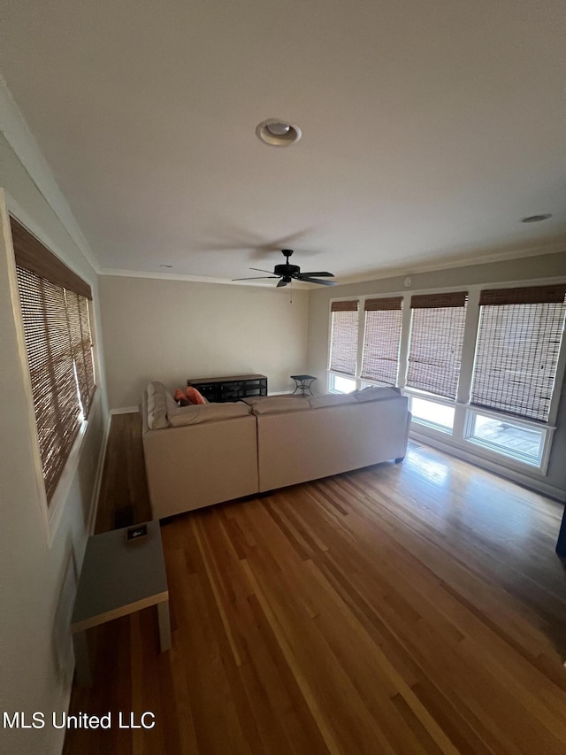 unfurnished living room with crown molding, hardwood / wood-style flooring, and ceiling fan