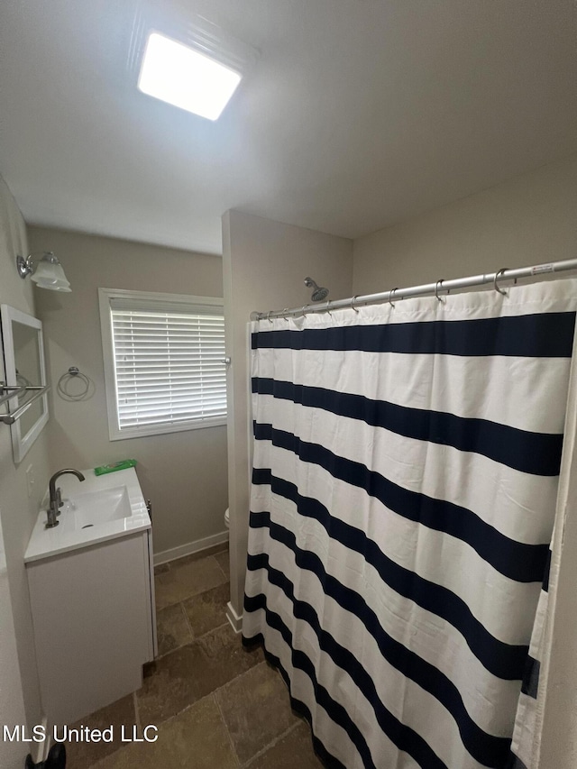 bathroom featuring vanity, a shower with curtain, and toilet