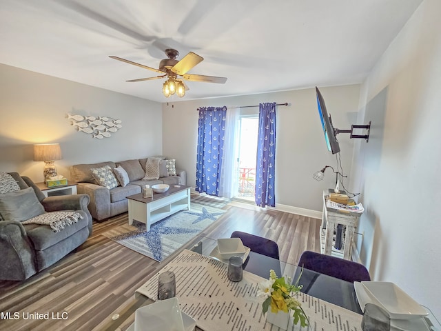 living room with wood-type flooring and ceiling fan