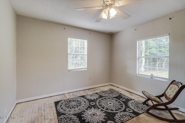 sitting room with light hardwood / wood-style floors and ceiling fan