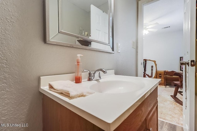 bathroom featuring vanity, ceiling fan, and hardwood / wood-style floors