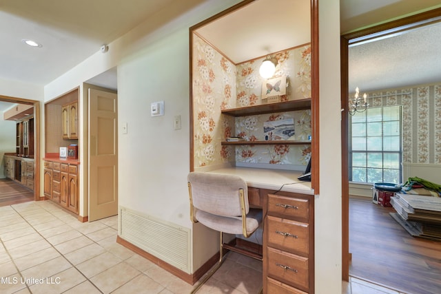 524 Champlin St, Gulfport, MS 39507 - office space featuring built in study area, wallpapered walls, a chandelier, light tile patterned flooring, and baseboards