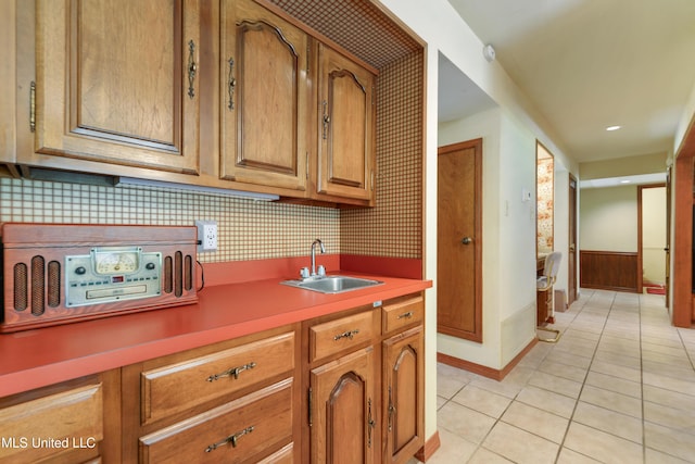 524 Champlin St, Gulfport, MS 39507 - kitchen with a sink, light tile patterned floors, brown cabinets, baseboards, and light countertops