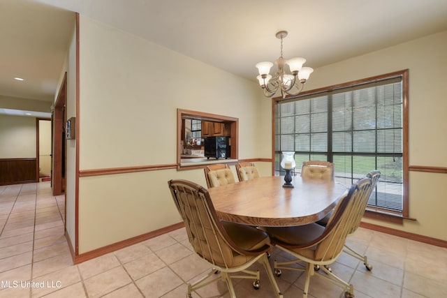 524 Champlin St, Gulfport, MS 39507 - dining area featuring a chandelier, light tile patterned floors, and baseboards