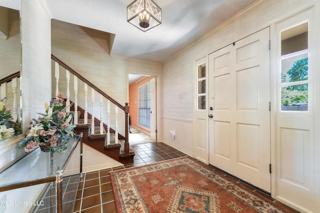 524 Champlin St, Gulfport, MS 39507 - tiled entrance foyer featuring ornamental molding, stairs, and baseboards