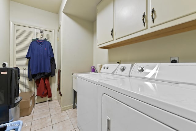 524 Champlin St, Gulfport, MS 39507 - washroom with cabinet space, washer and dryer, light tile patterned flooring, and baseboards
