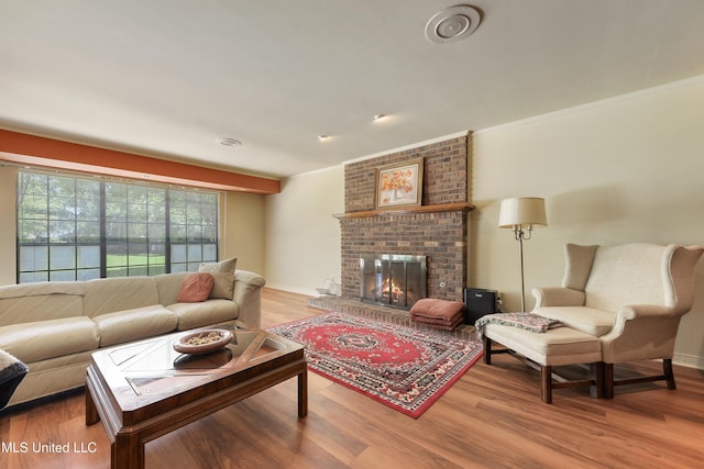 524 Champlin St, Gulfport, MS 39507 - living room with wood finished floors, a brick fireplace, baseboards, and ornamental molding