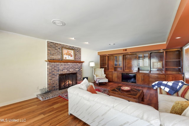 524 Champlin St, Gulfport, MS 39507 - living area with a fireplace, wood finished floors, crown molding, baseboards, and recessed lighting
