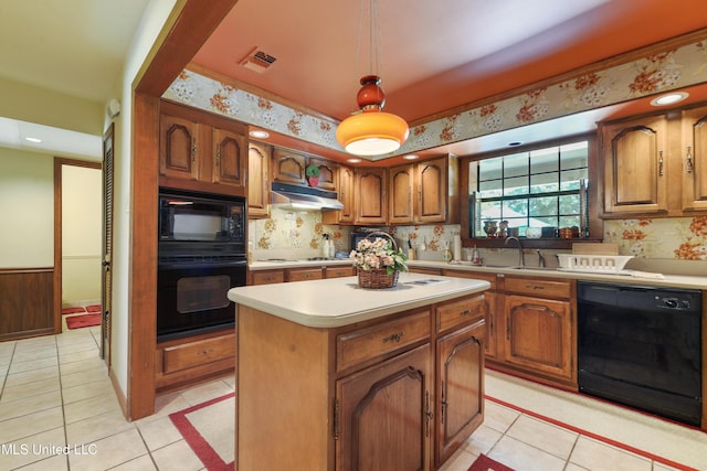 524 Champlin St, Gulfport, MS 39507 - kitchen with black appliances, under cabinet range hood, a sink, light countertops, and light tile patterned floors