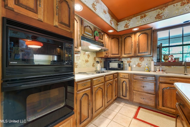 524 Champlin St, Gulfport, MS 39507 - kitchen with black appliances, brown cabinetry, and under cabinet range hood