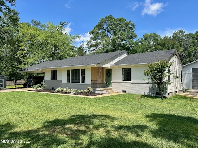 308 College St, Carthage, MS 39051 - single story home featuring roof with shingles, an outdoor structure, a front yard, and a carport