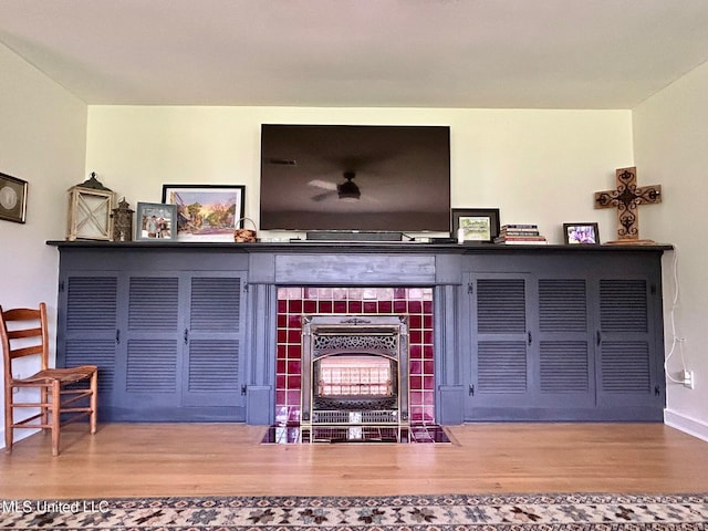 308 College St, Carthage, MS 39051 - room details with a tiled fireplace, baseboards, and wood finished floors