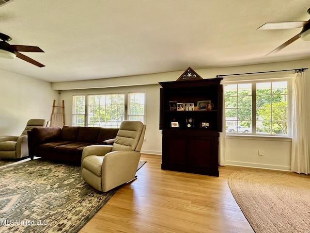 308 College St, Carthage, MS 39051 - living area with baseboards, a ceiling fan, and light wood-style flooring