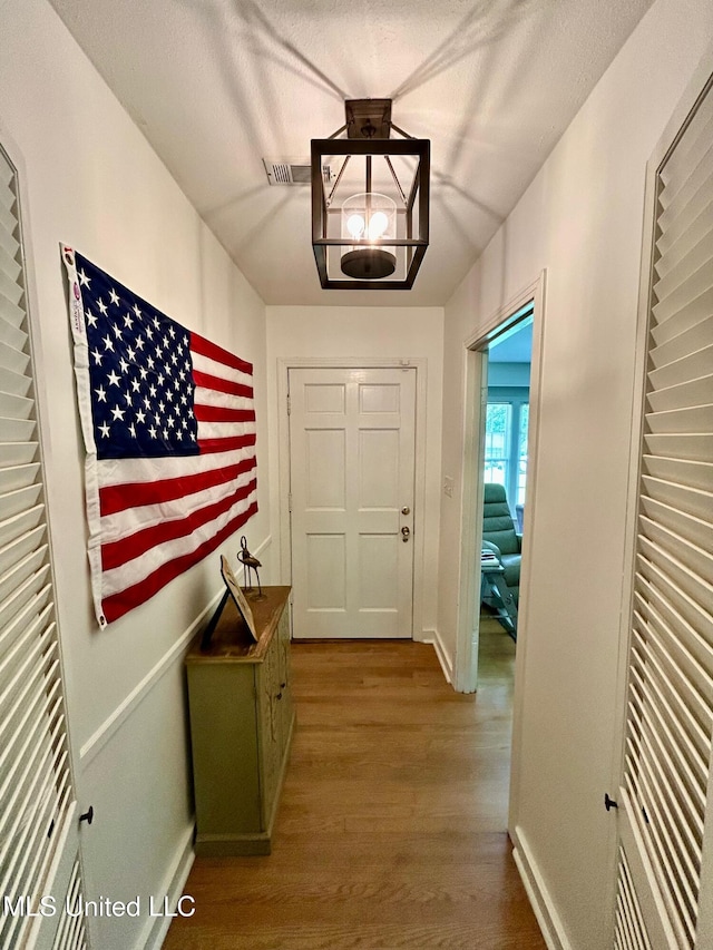 308 College St, Carthage, MS 39051 - doorway with baseboards, visible vents, and wood finished floors